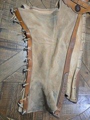vintage western chaps feature a hand-tooled floral motif on the yoke