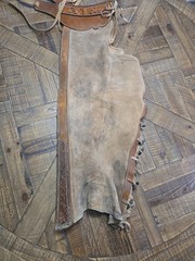 vintage western chaps feature a hand-tooled floral motif on the yoke
