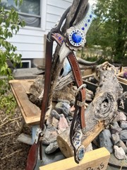 Western horse headstall featuring blue rhinestones and cowhide inlays