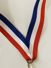 Male Track medal, shield shape 3″ x 2.5″ diameter, with ribbon, & engraving