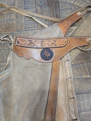 vintage western chaps feature a hand-tooled floral motif on the yoke