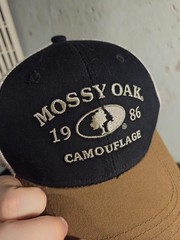 Mossy Oak 1986 Camouflage Trucker Hat | Black/Brown Mesh Back Snapback OSFM