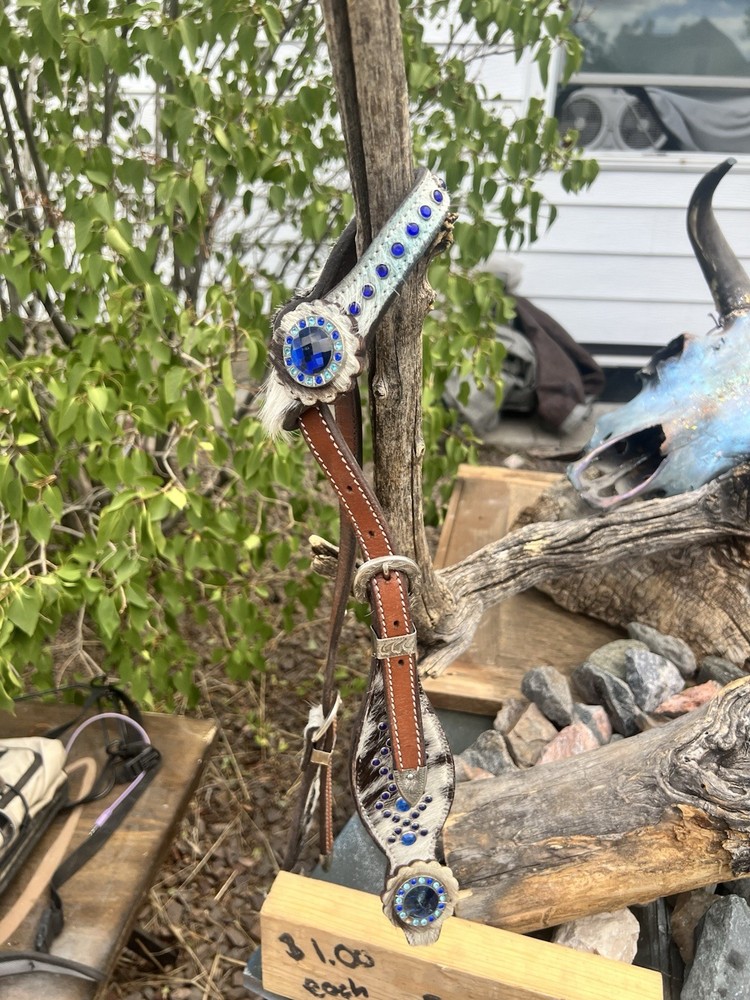 Western horse headstall featuring blue rhinestones and cowhide inlays