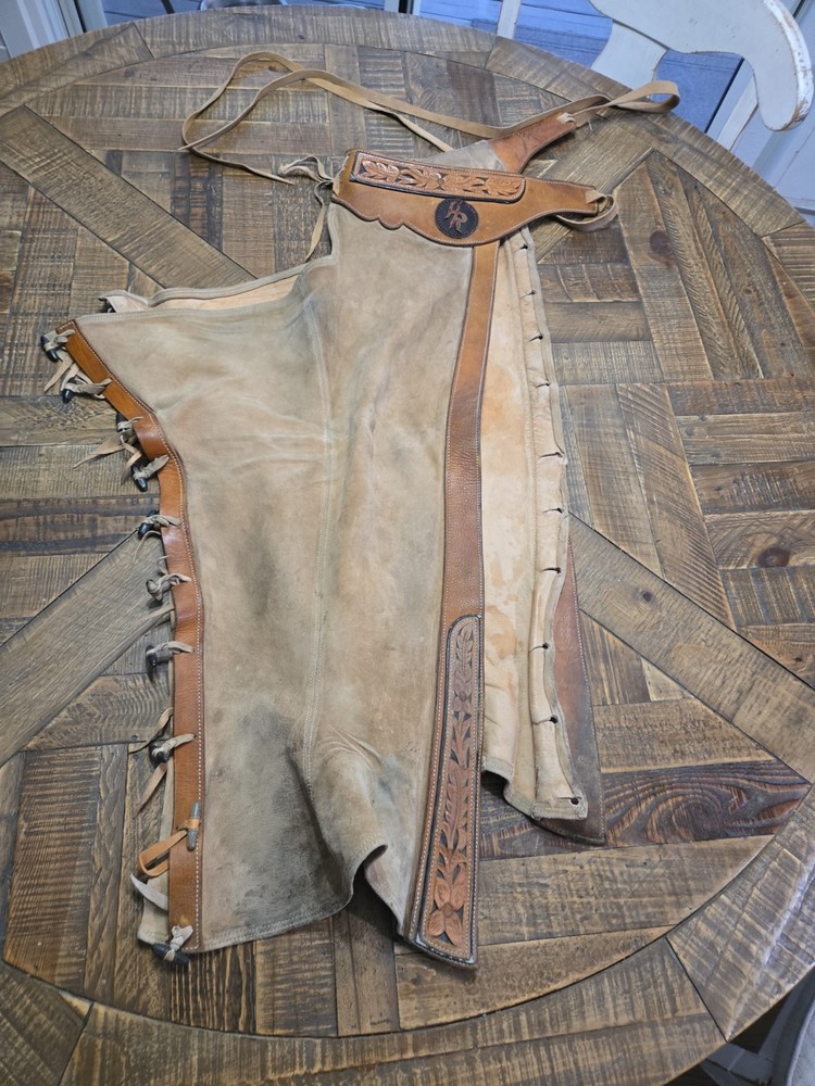 vintage western chaps feature a hand-tooled floral motif on the yoke