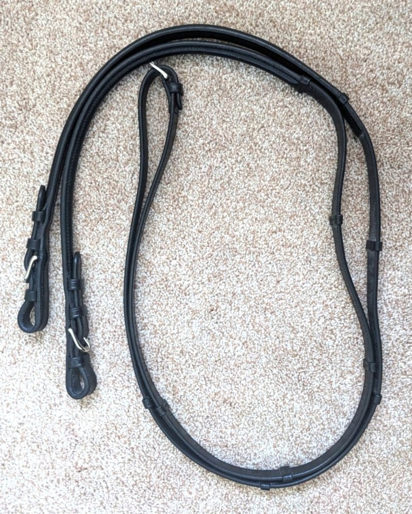 Bobby’s black leather flat English reins with hand stops and center buckle 54 in