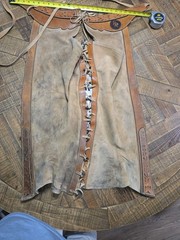 vintage western chaps feature a hand-tooled floral motif on the yoke