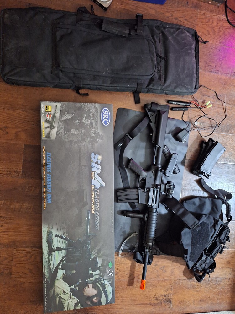 Airsoft Kit (SRC M4A1), Vest, Bag, Glasses, and Vest. With red dot and grip.