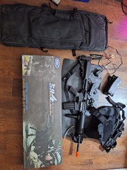 Airsoft Kit (SRC M4A1), Vest, Bag, Glasses, and Vest. With red dot and grip.