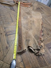 vintage western chaps feature a hand-tooled floral motif on the yoke