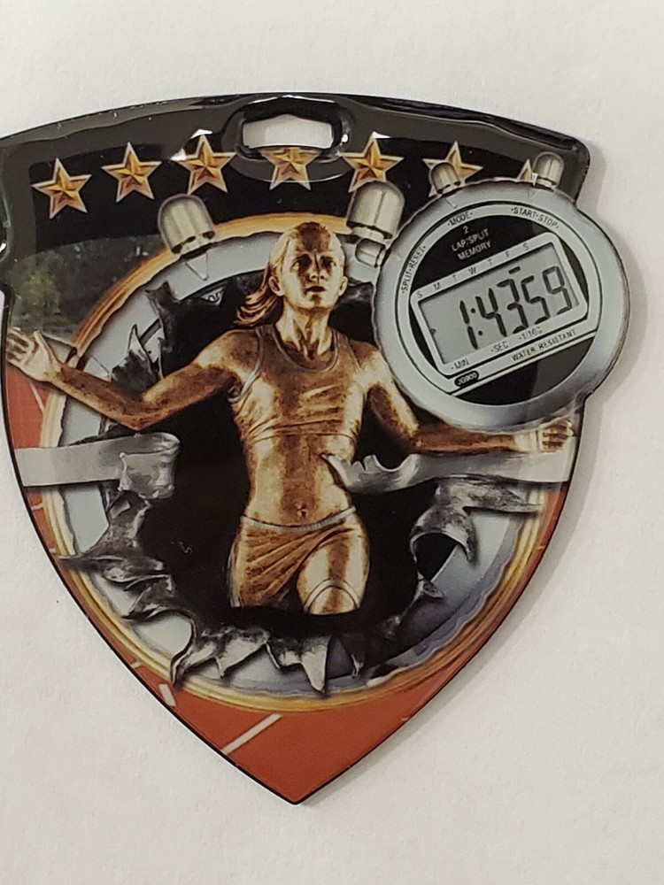 Female Track medal, shield shape 3″ x 2.5″ diameter, with ribbon, & engraving