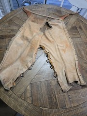 vintage western chaps feature a hand-tooled floral motif on the yoke